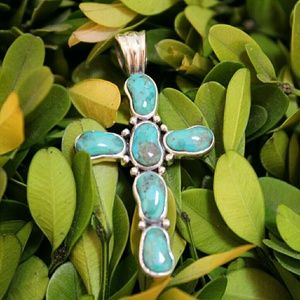Sterling silver and turquoise cross pendant.